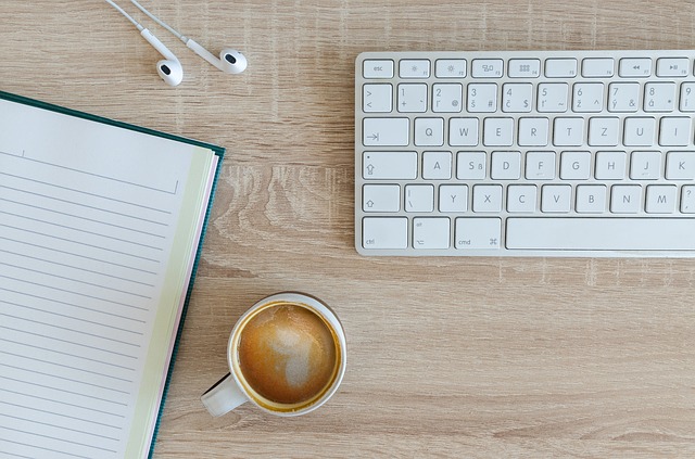 computer keyboard, coffee and notebook