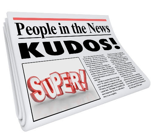 newspaper with headline saying Kudos