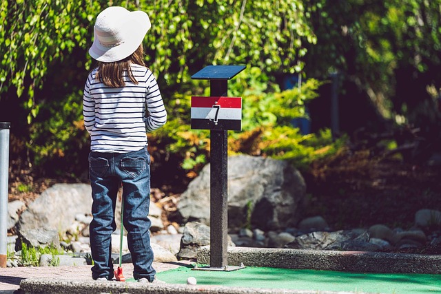 child at mini golf hole